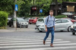 man crossing the street on a pedestrian lane