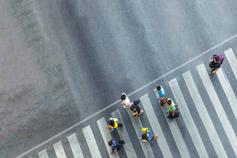 group of people crossing the street on a pedestrian lane