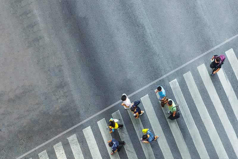 group of people crossing the street on a pedestrian lane