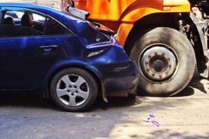 blue car and orange truck road collision