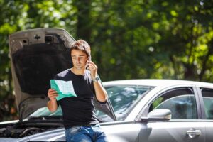 Man reading car insurance while talking on the phone