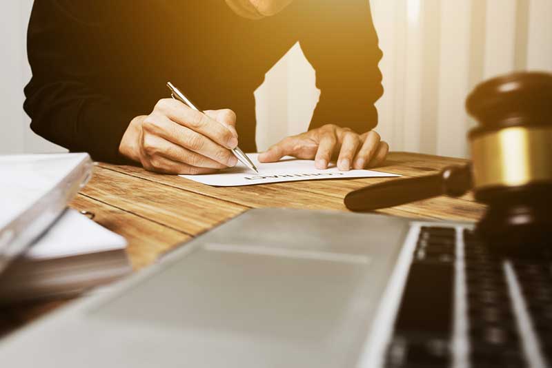 lawyer signing documents