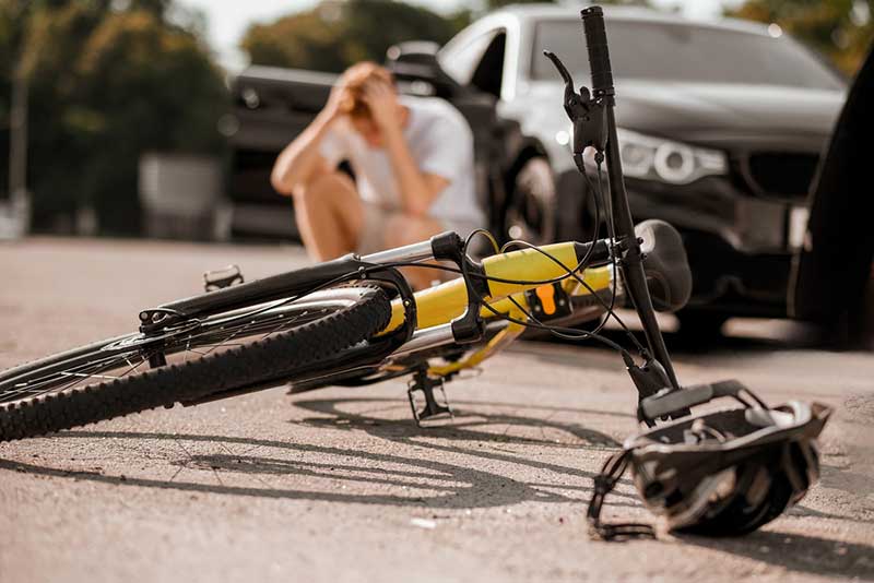 yellow bicycle on ground after accident
