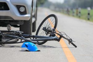 bicycle hit by a gray car